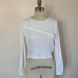 Cream blouse with cropped fit & elastic shirring.